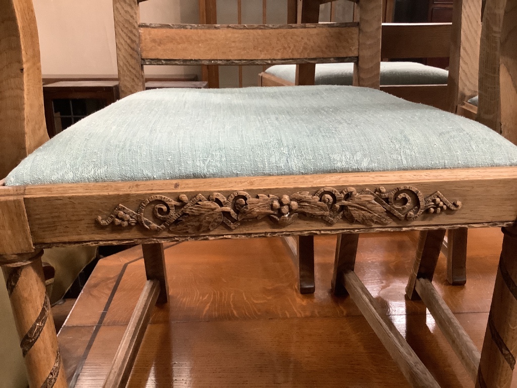 A set of six 1920's oak dining chairs two with arms